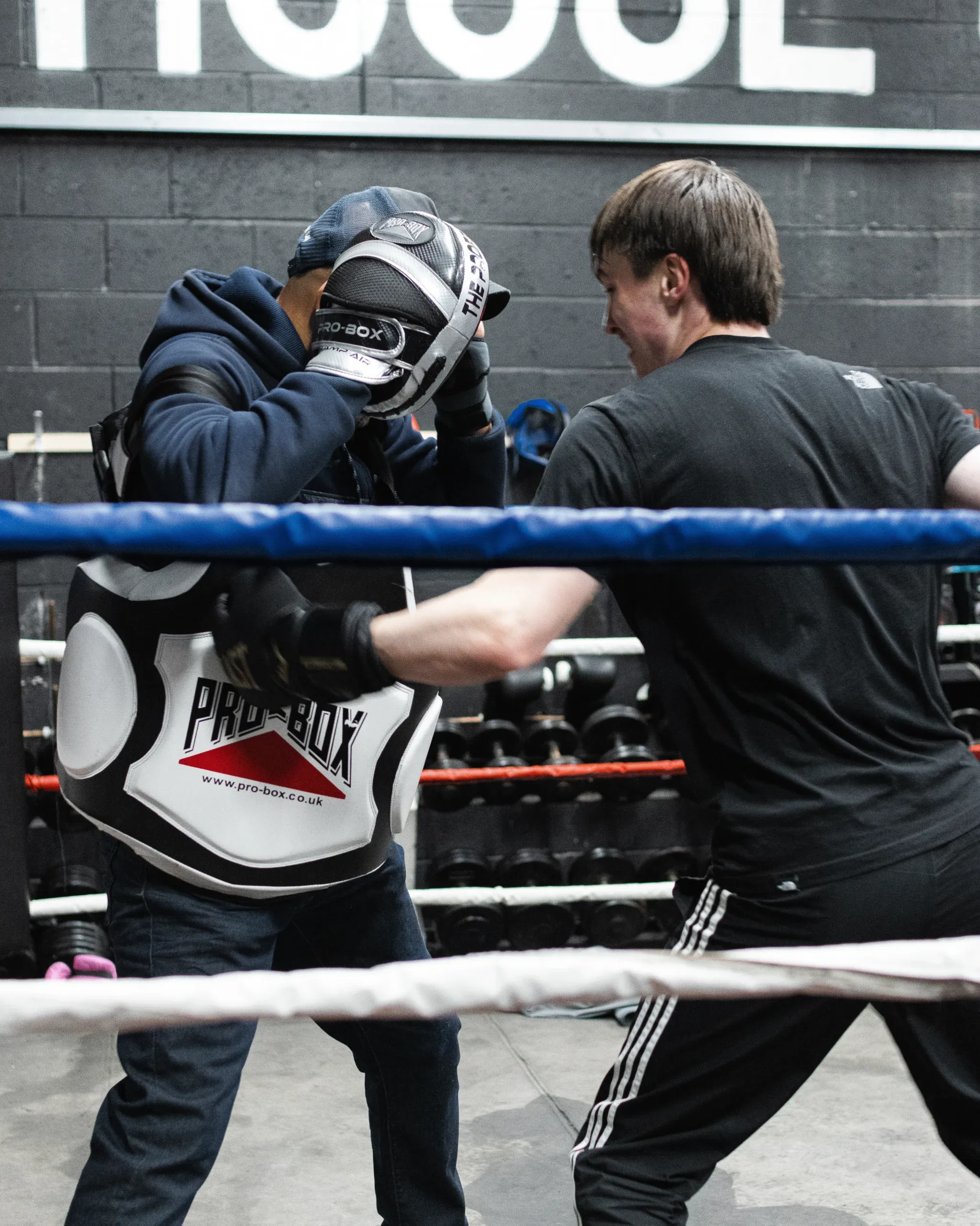 A boxer working the heavy bag at Fight Academy Coventry